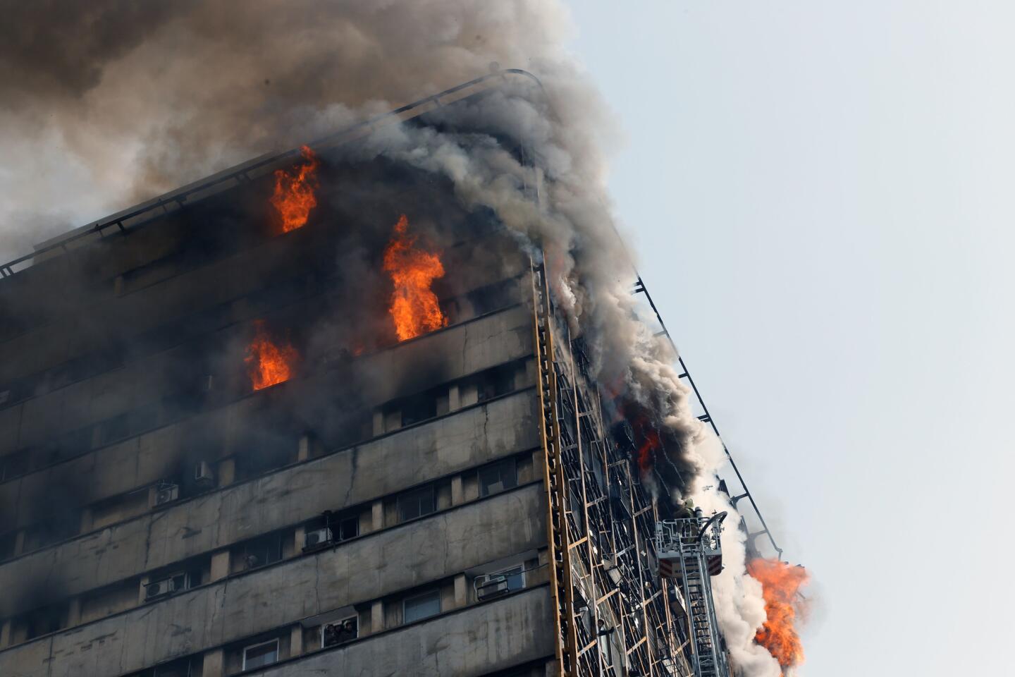 Burning Tehran high-rise collapses