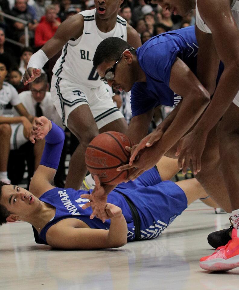 Windward's Devin Tillis and teammate Brandon Richard scramble for a loose ball against Sierra Canyon's Bronny James (0) and Terren Frank.