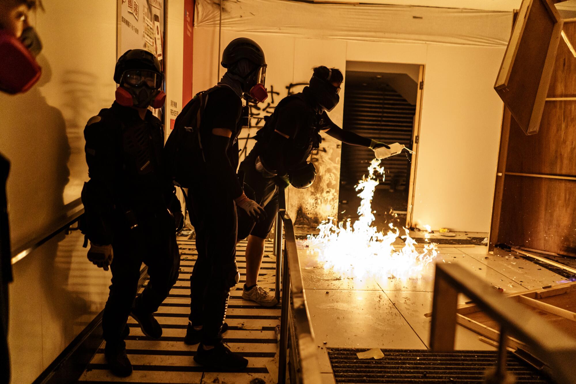Protesters set fire to the interior of Bank of Chine, in the Mong Kok district of Hong Kong.