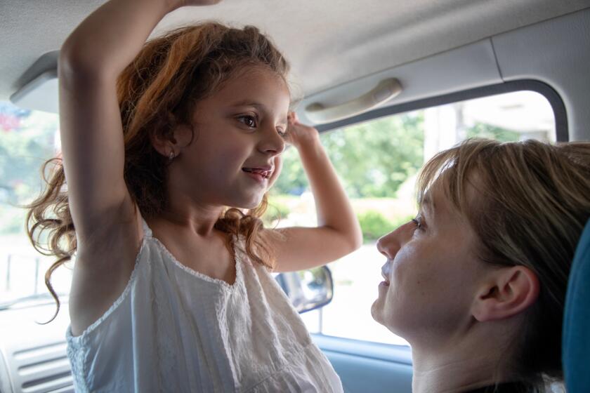 A child sits on a woman's lap.