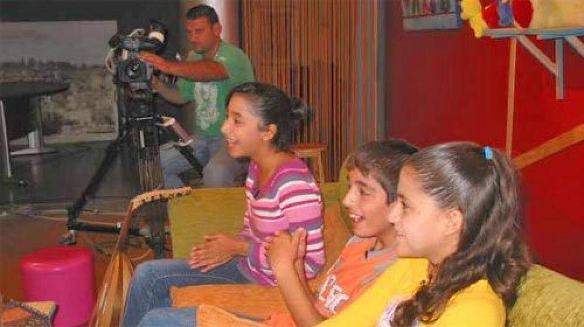 NEW VOICES: From left, Israeli Arabs Maram abu Ahmad, 12; Tony Khleif, 11; and Shahd Shahbari, also 11, answer questions on a variety of often-sensitive issues on a weekly half-hour program called Haki Kibar, or Grown-Up Talk.