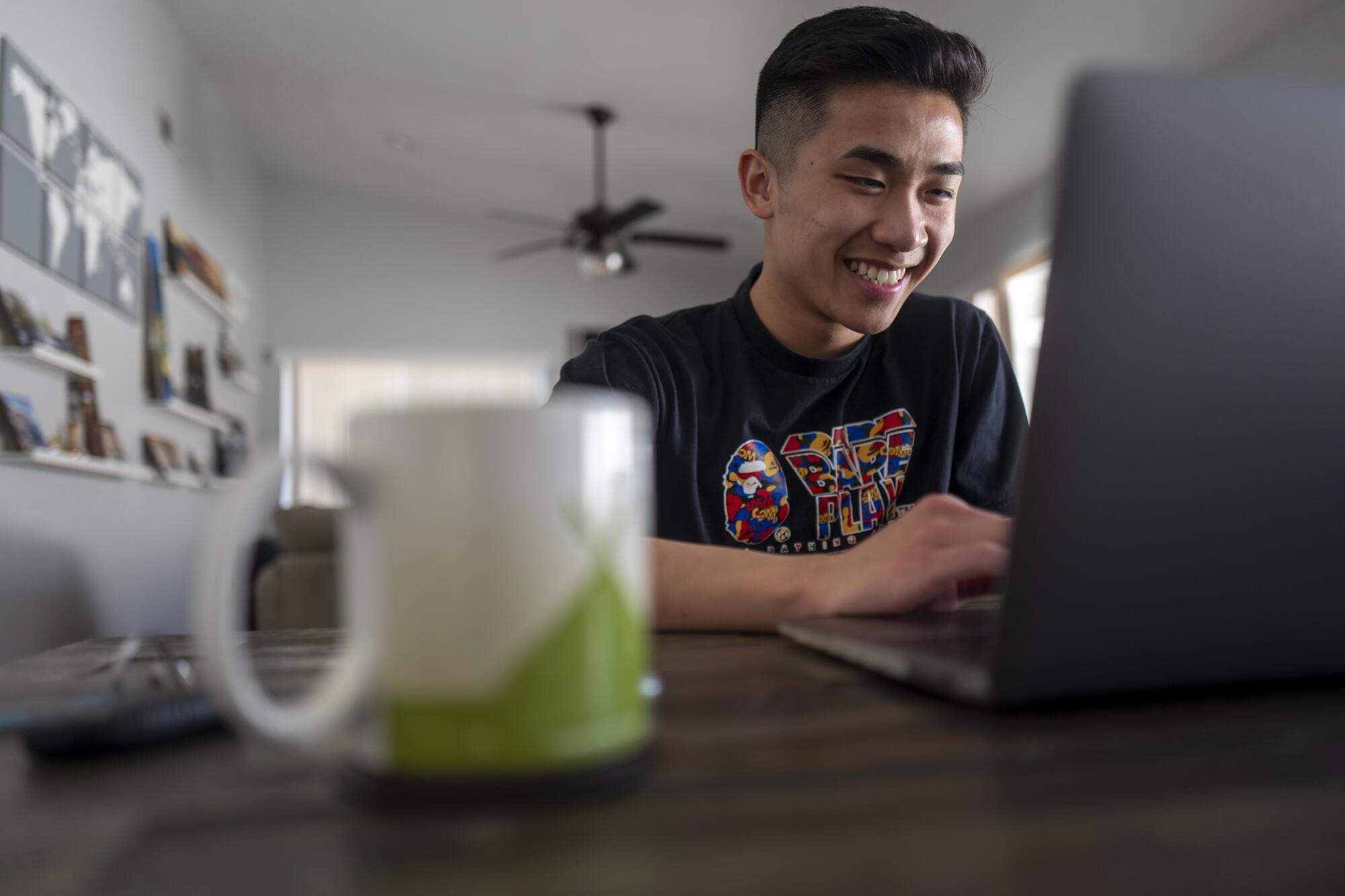 Ryan Fung sits at a computer 