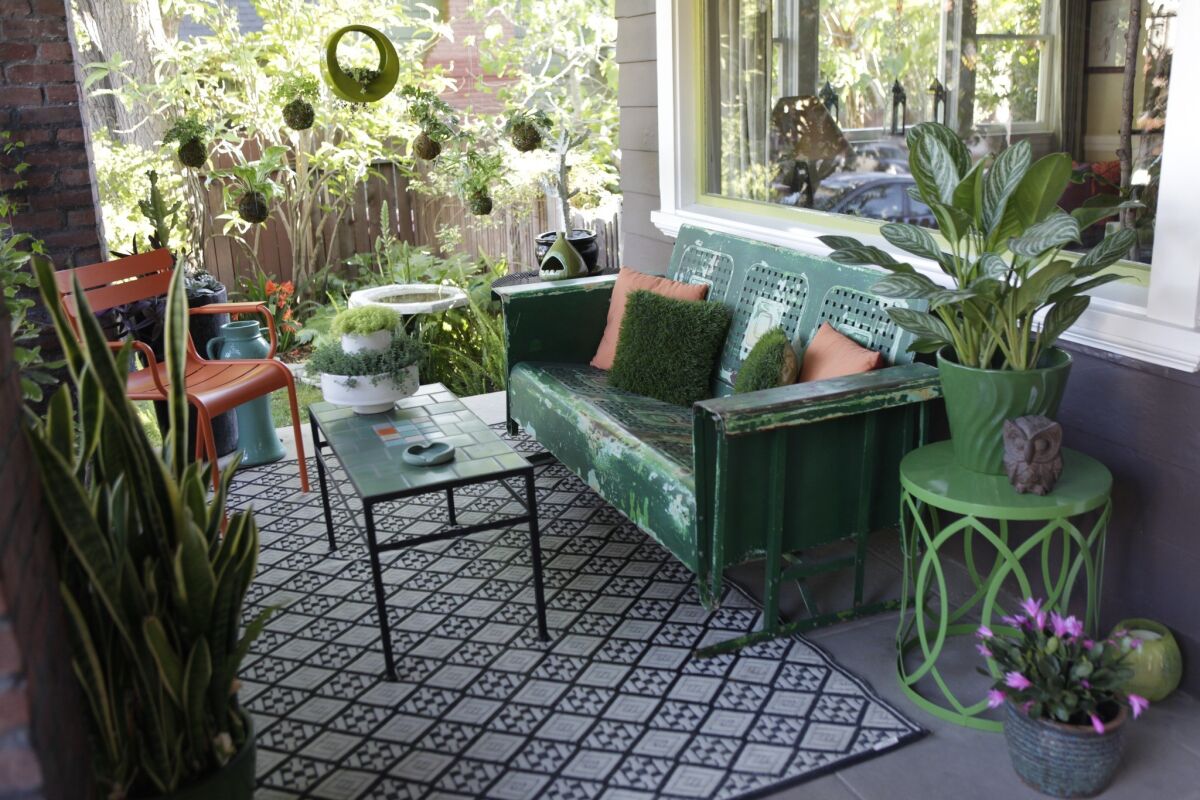 A Hollywood front porch is transformed into a stylish outdoor room with a recycled plastic rug from Mad Mats. 