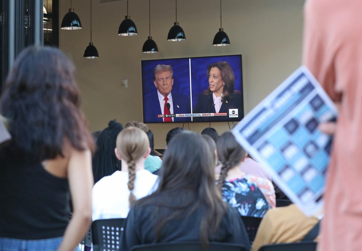 A student holds his bingo card during Tuesday night's presidential debate watch party at Vanguard University.