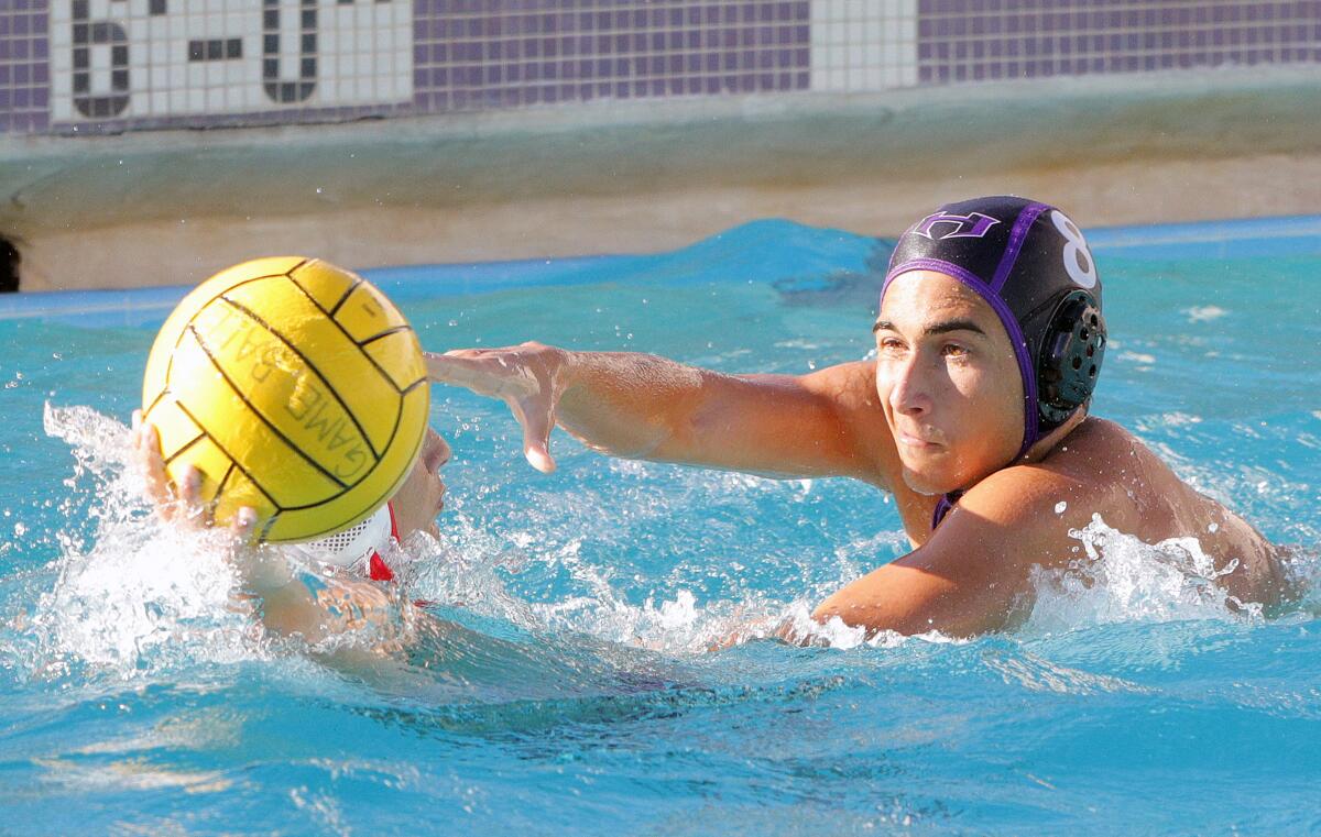 Hoover's Eric Begijani reaches on defense for the ball being held back by Glendale's Hamlet Tadevosyan in a Pacific League boys' water polo match at Hoover High School on Wednesday, October 23, 2019. Hoover defeated Glendale 12-11 after coming from behind in the fourth quarter to win the match.