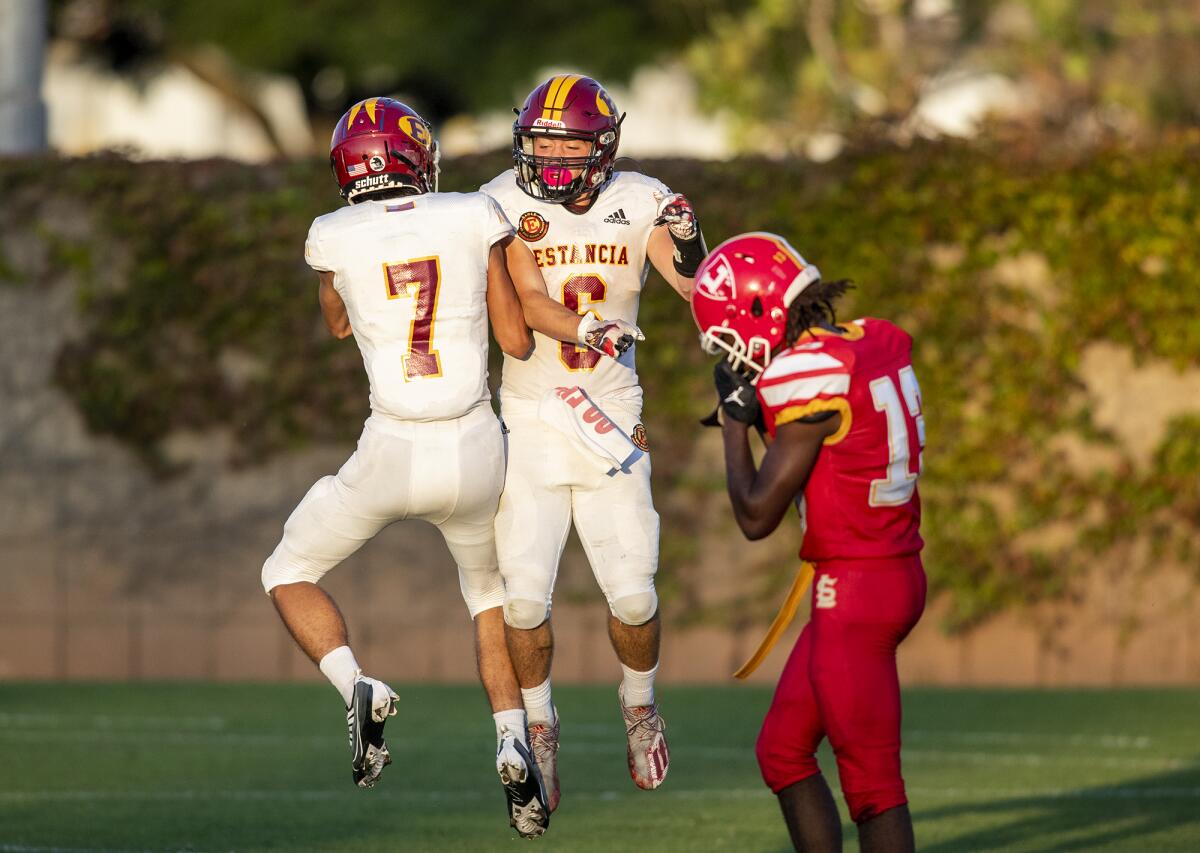 Estancia's David Bautista, left, celebrates with Noah Aires after he scored a touchdown during a game against Loara.