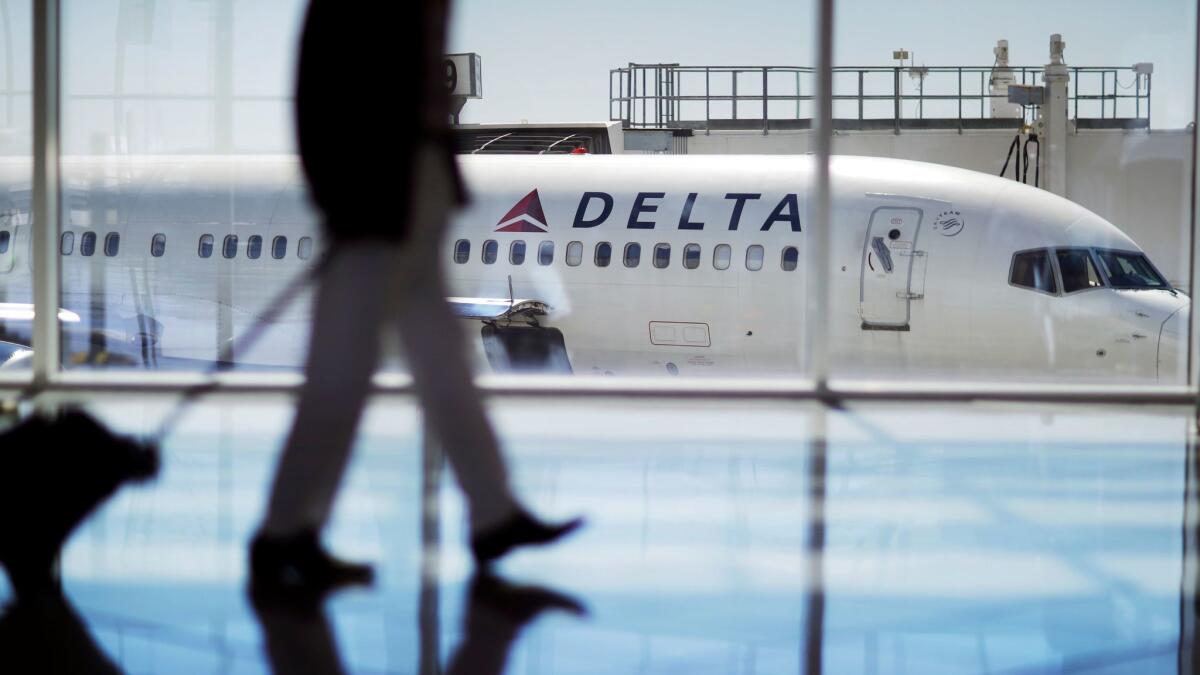 A Delta Air Lines jet sits at a gate at Hartsfield-Jackson Atlanta International Airport. Delta canceled about 3,000 flights in the aftermath of April storms that hit its Atlanta hub.