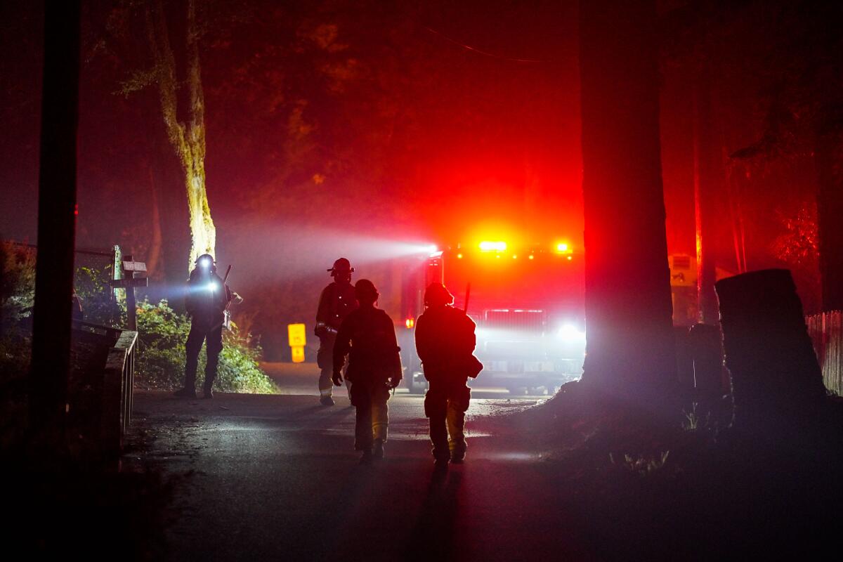 Firefighters respond to the CZU Lightning Complex fire in Boulder Creek last month.