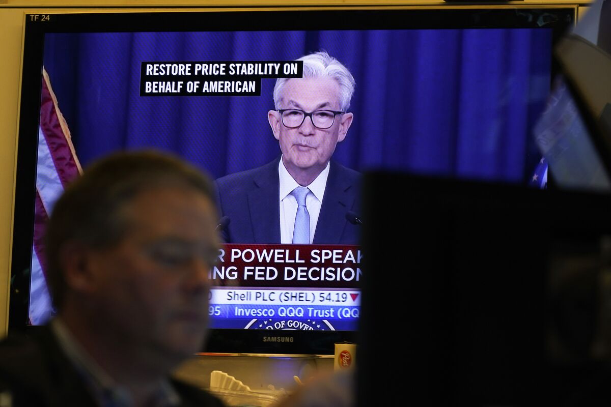 Federal Reserve Chairman Jerome Powell news conference is displayed on televisions while traders work on the floor at the New York Stock Exchange in New York, Wednesday, June 15, 2022. The Federal Reserve on Wednesday intensified its drive to tame high inflation by raising its key interest rate by three-quarters of a point — its largest hike in nearly three decades — and signaling more large rate increases to come that would raise the risk of another recession. (AP Photo/Seth Wenig)