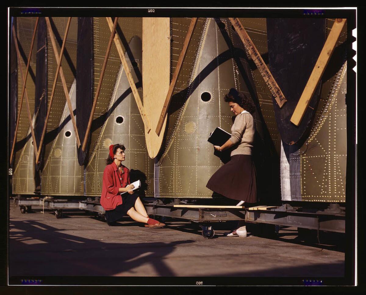 Female inspectors at the Long Beach plant of Douglas Aircraft Co. make a careful check of center wings for C-47 transport planes. October 1942.