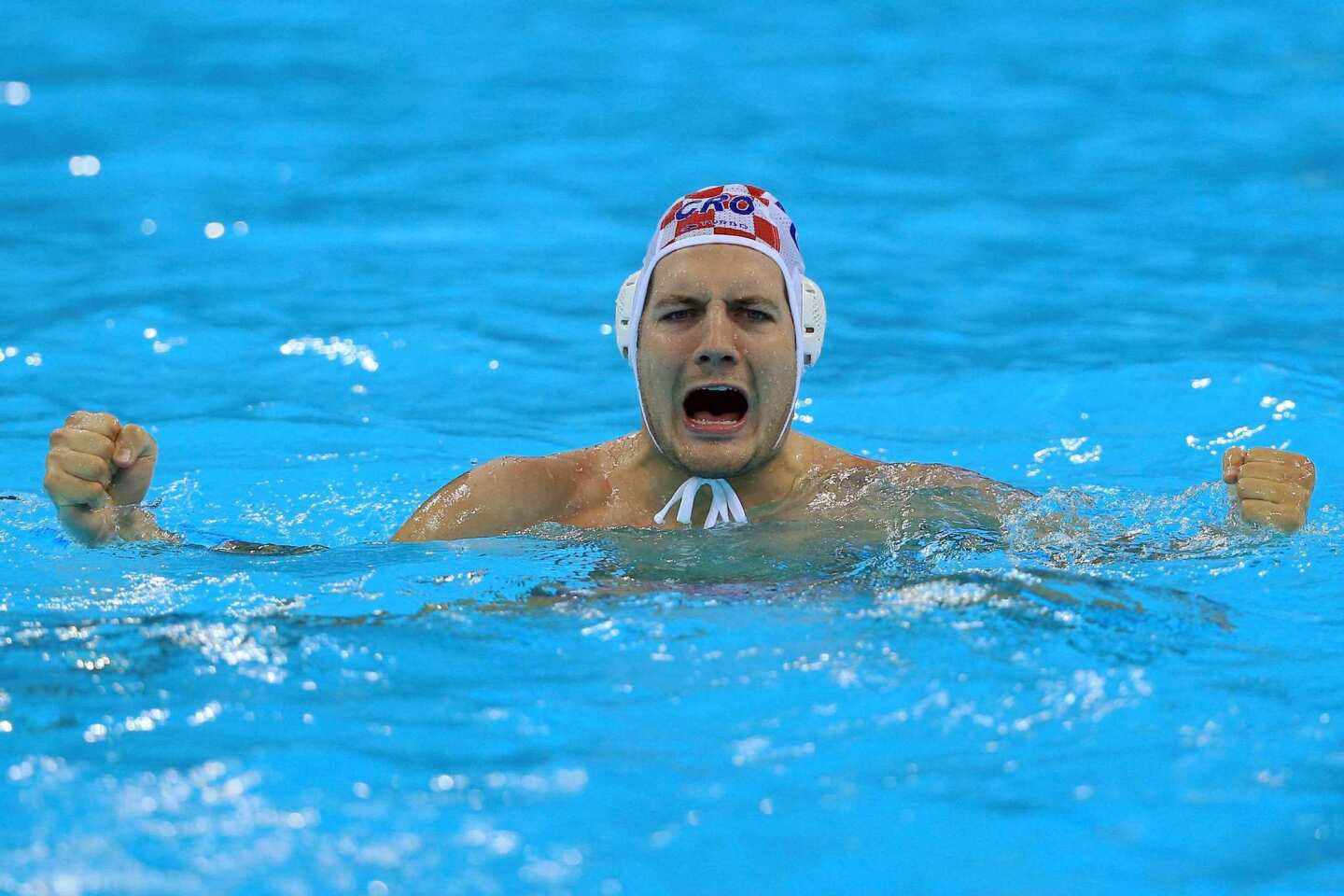 Andro Buslje of Croatia celebrates winning the men's water polo quarterfinal match against the United States.