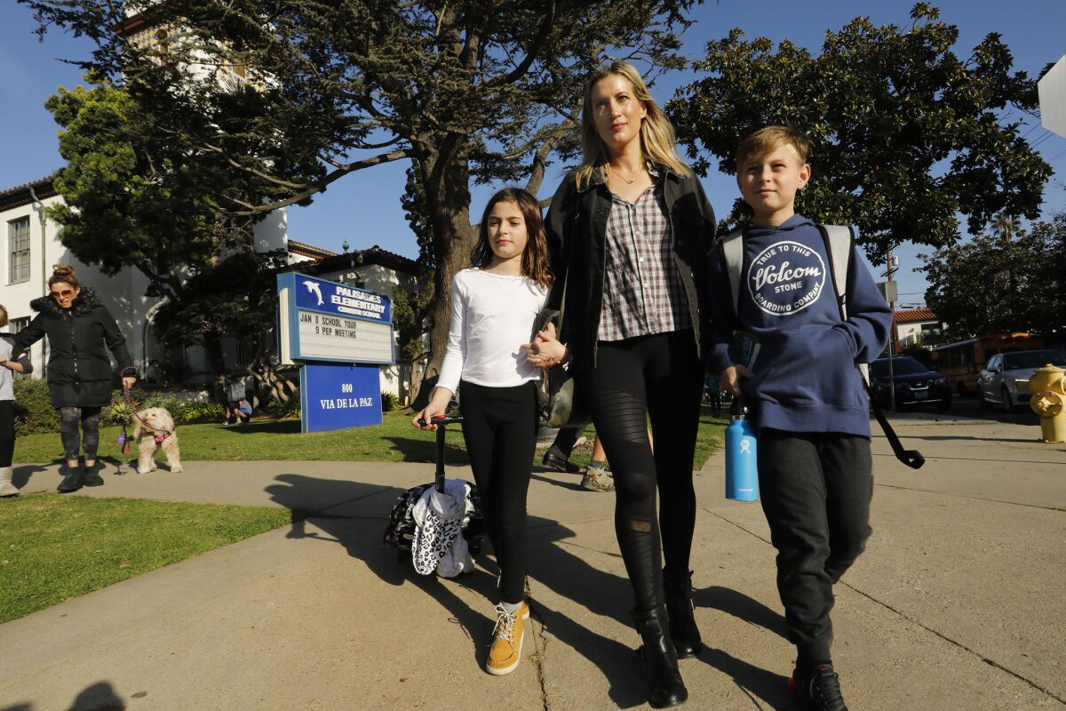 Shannon Soller picks up her children, Presley and Cooper, from Pacific Palisades Charter Elementary School. Soller supports the teachers union but is concerned that keeping children out of class costs schools money.