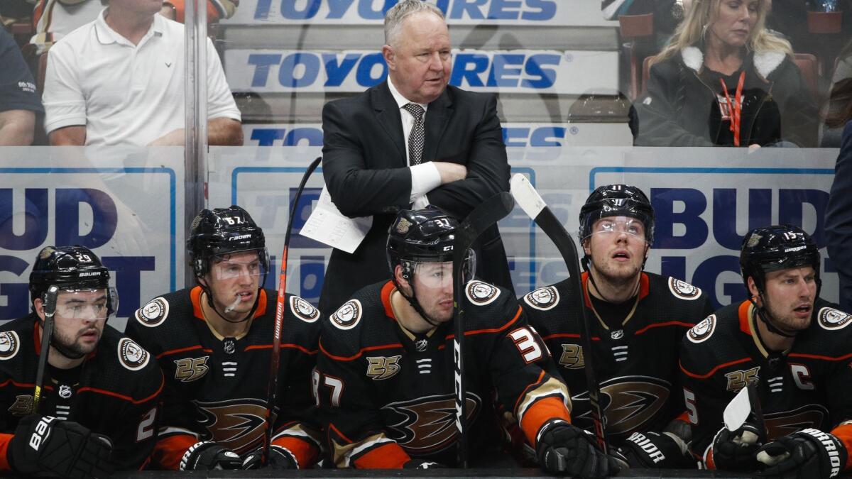 Ducks coach Randy Carlyle, center, watches during the third period against the St. Louis Blues on Jan. 23.