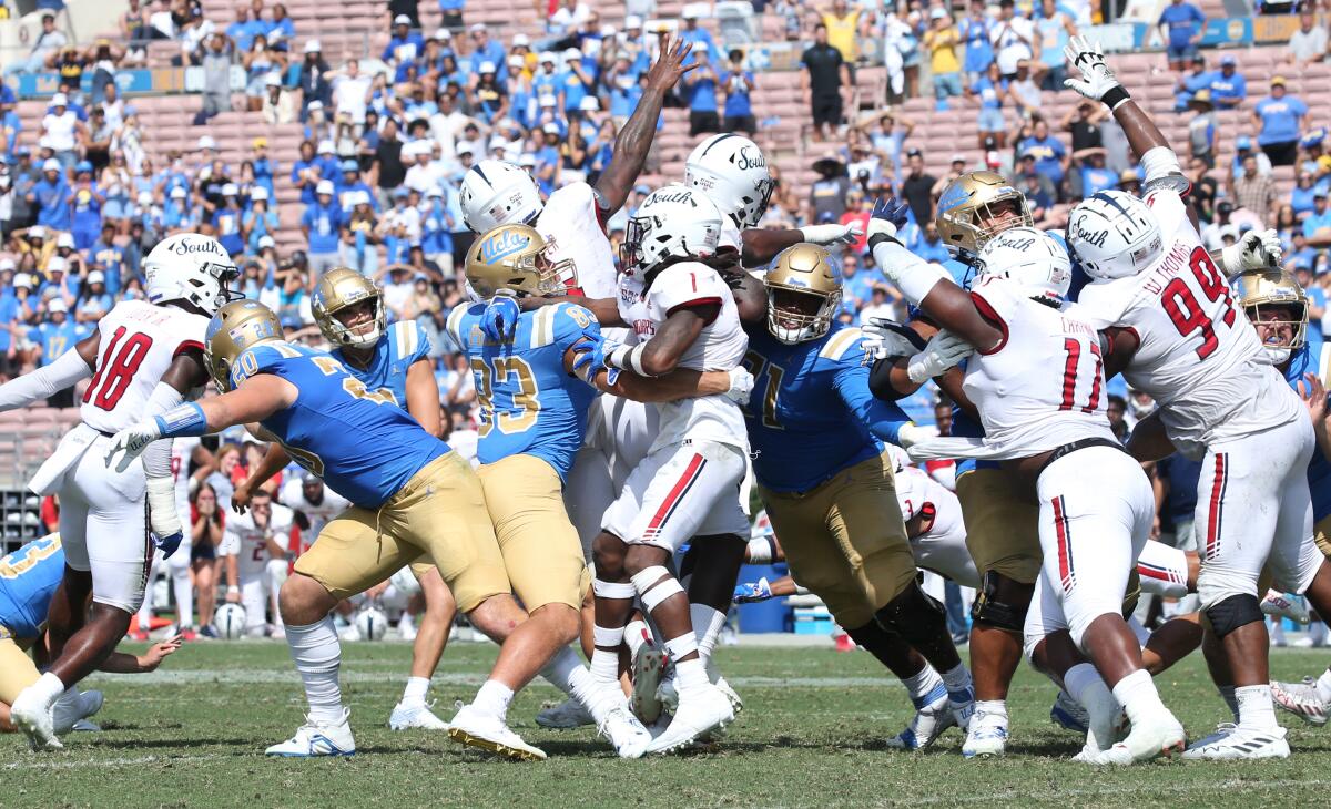 UCLA kicker Nicholas Barr-Mira  — fourth from left, facing forward — watches his game-winning field goal Sept. 17, 2022.
