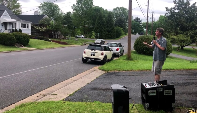 David Newman conducts in May in his Harrisonburg, Va., driveway while testing his idea for choirs to sing from cars.