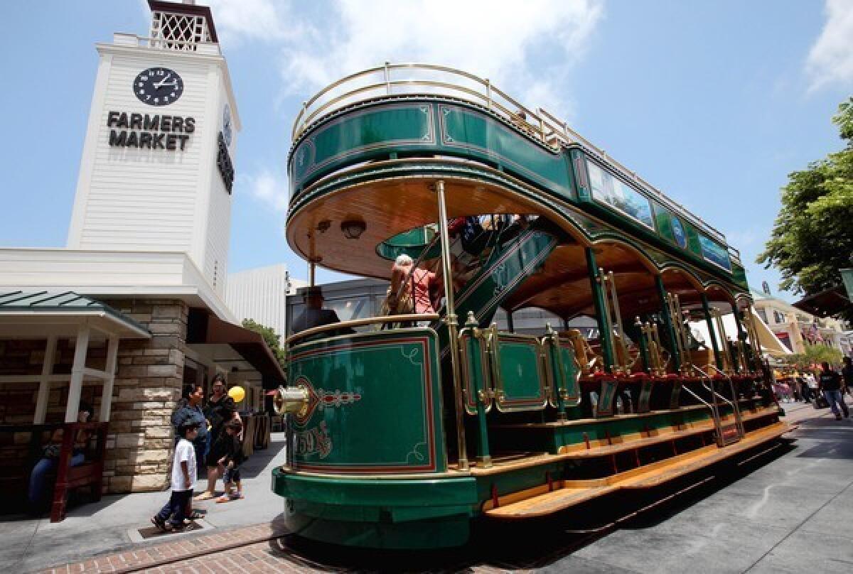 And old-fashioned trolley ferries visitors through the Grove shopping center. Rick Caruso envisions expanding it to other sites in the neighborhood.