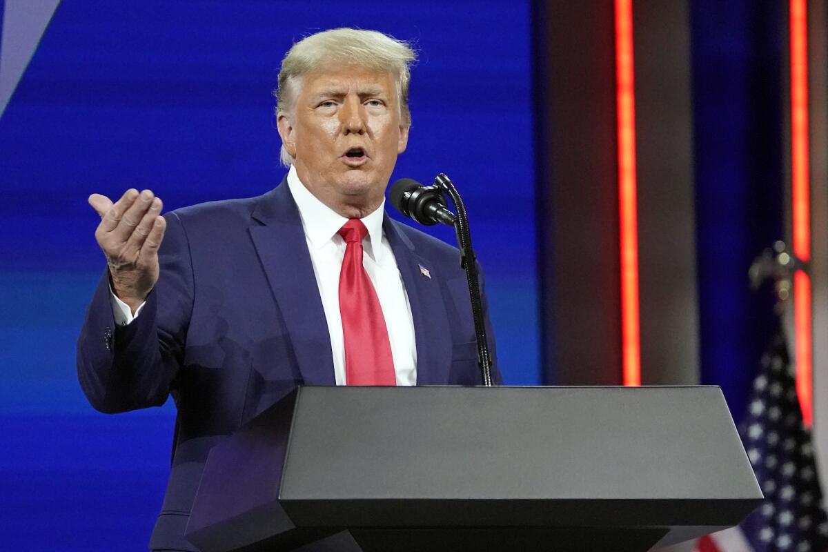 Ex-President Donald Trump speaks at a lectern