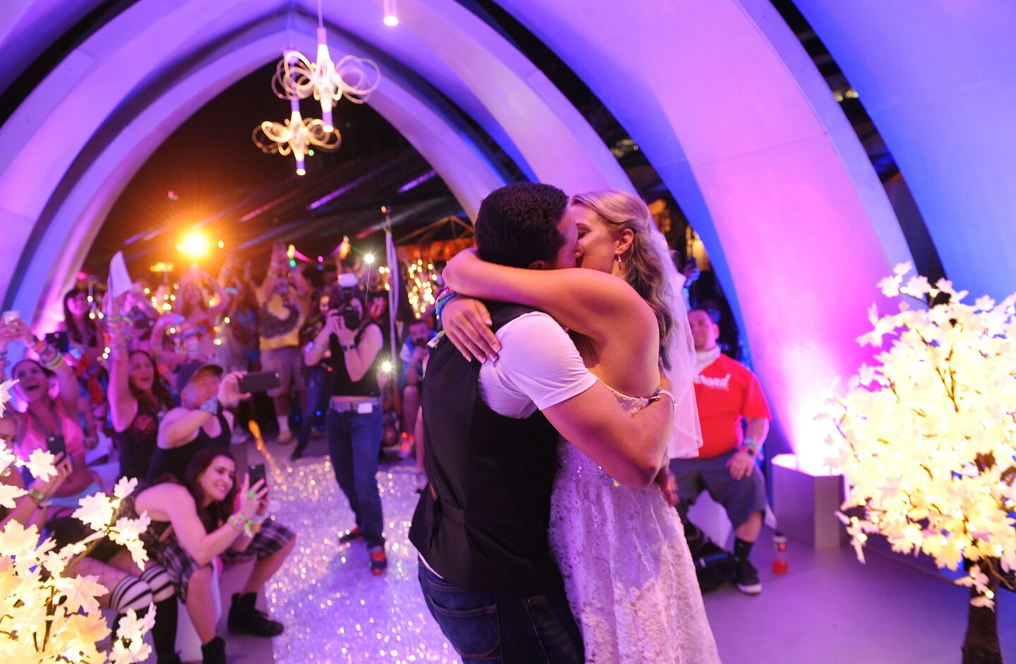 Alexandre and Jessica Montes kiss as they are wed at the chapel of technology during the Electric Daisy Carnival in Las Vegas on June 17.