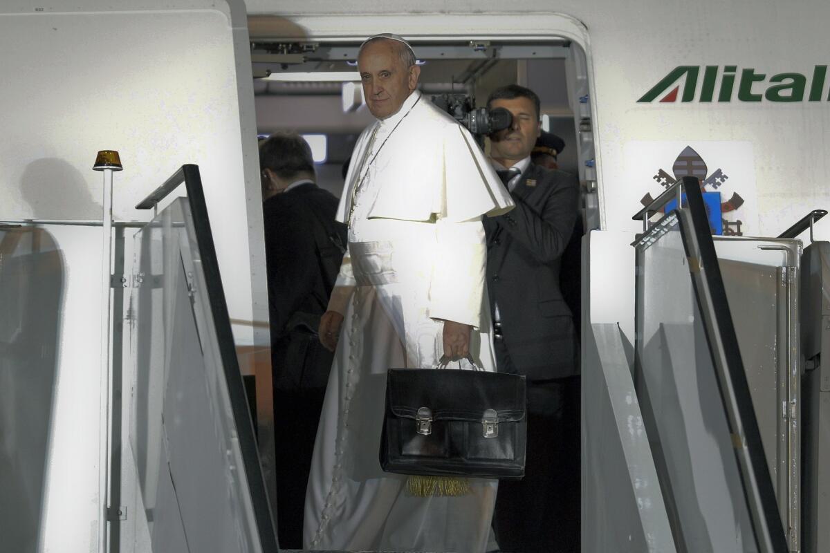 Pope Francis boards a plane Sunday night in Rio de Janeiro after concluding a weeklong trip to Brazil.