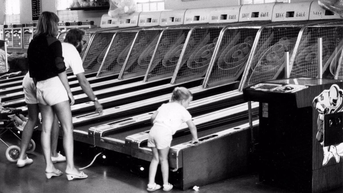 A family plays Skee-Ball inside Bay Arcade in 1970. The arcade has been open in the Fun Zone area of Balboa Village since the 1950s.