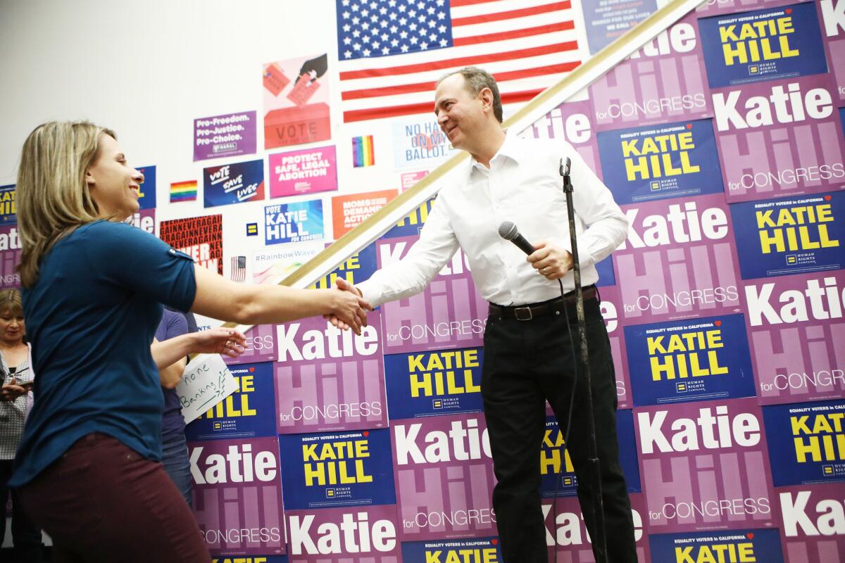 Rep. Adam Schiff shakes hands with Democratic congressional candidate Katie Hill at a canvass launch at Hill's headquarters on November 5.