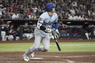 Los Angeles Dodgers' Shohei Ohtani hits a single against the Arizona Diamondbacks.