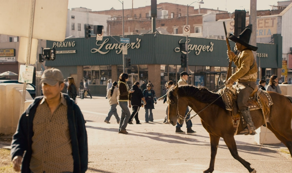 A film still shows a Mexican revolutionary on horseback wandering into the intersection in front of Langer's deli