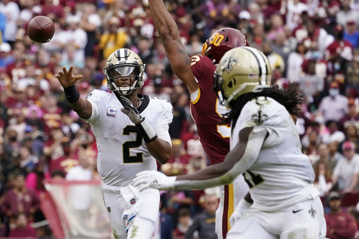 New Orleans Saints quarterback Jameis Winston (2) throws a touchdown pass to running back Alvin Kamara in the second half of an NFL football game against the Washington Football Team, Sunday, Oct. 10, 2021, in Landover, Md. (AP Photo/Alex Brandon)