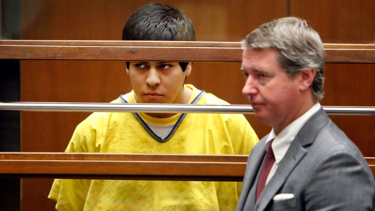 Andrew Garcia, left, appears with a public defender in Los Angeles Superior Court on Jan. 12, 2015, in connection with the 2014 beating death of USC graduate student Xinran Ji.