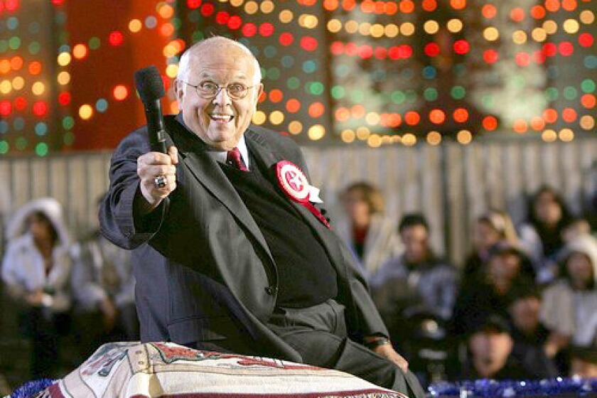 Johnny Grant, honorary mayor of Hollywood, flashes a smile in front of Grauman's Chinese Theatre during the 75th annual Hollywood Christmas Parade in 2006.