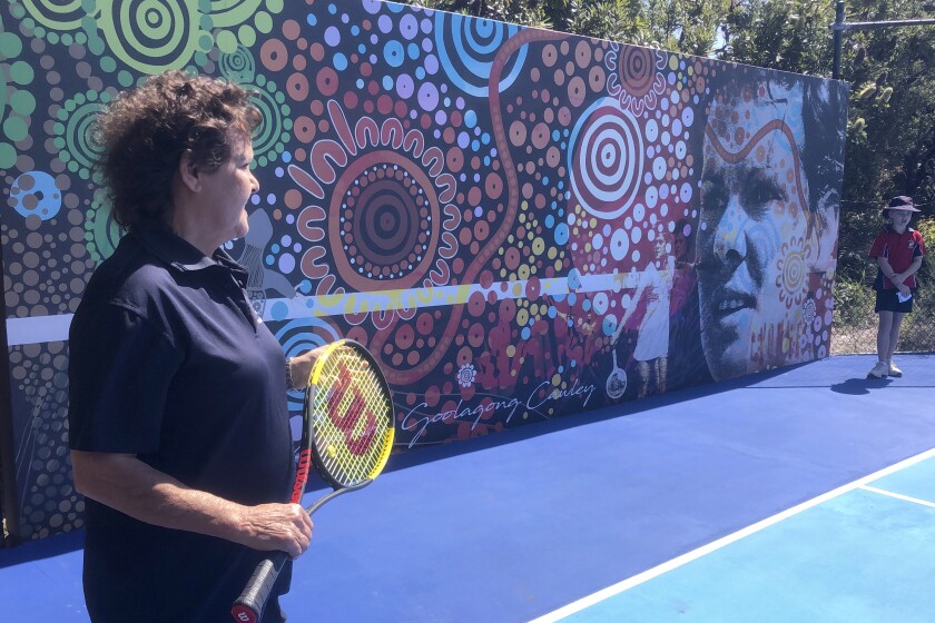 Evonne Goolagong Cawley, left, speaks as she returns to her tennis past in Noosa, Australia, Monday, Aug. 30, 2021, while hoping to inspire Australia's future in the sport. Goolagong Cawley helps unveil a mural, which will double as a hitting wall, as part of Tennis Australia's National Hitting Wall project at the former world No. 1′s local club. (AP Photo/Dennis Passa)
