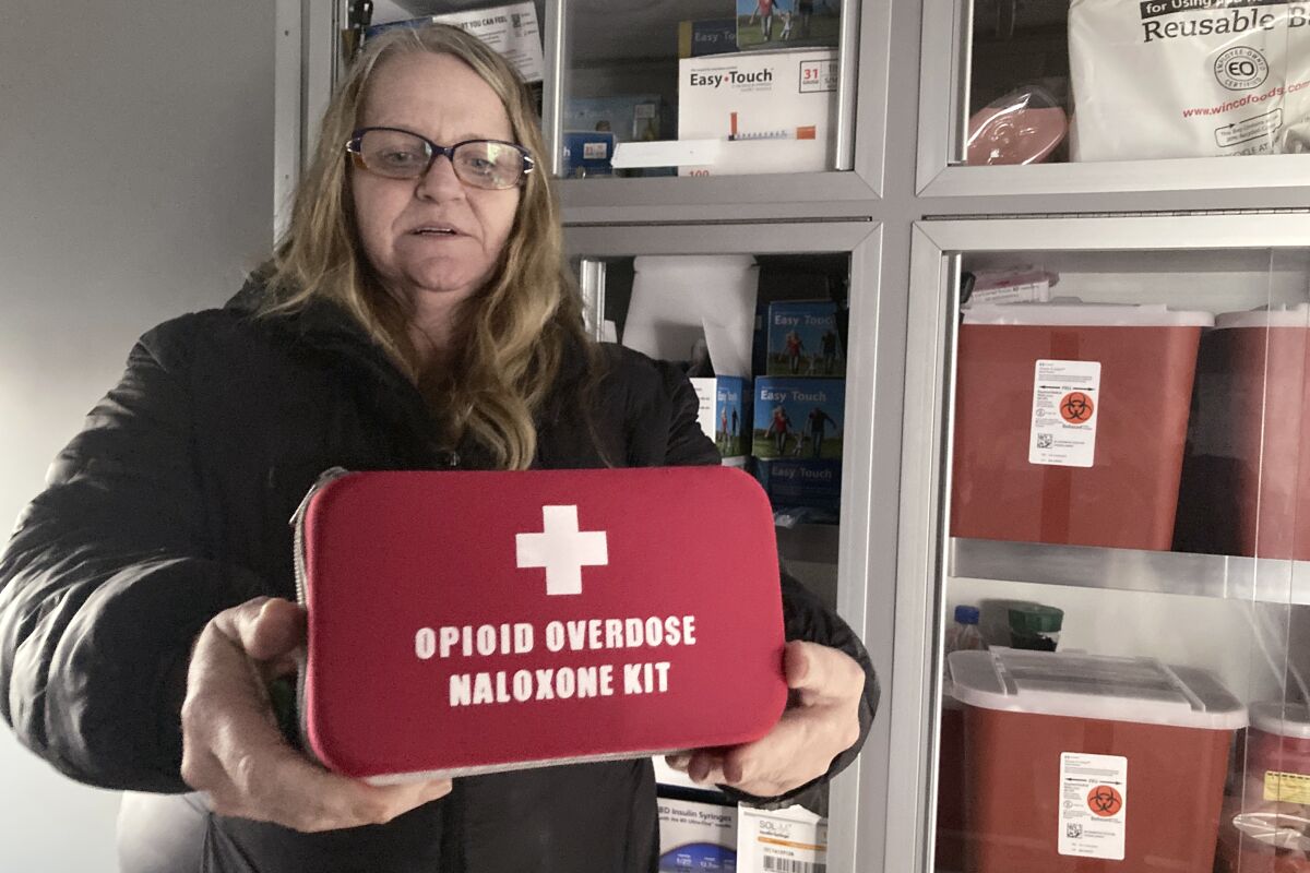 A woman holds an emergency kit used to treat opioid overdose.