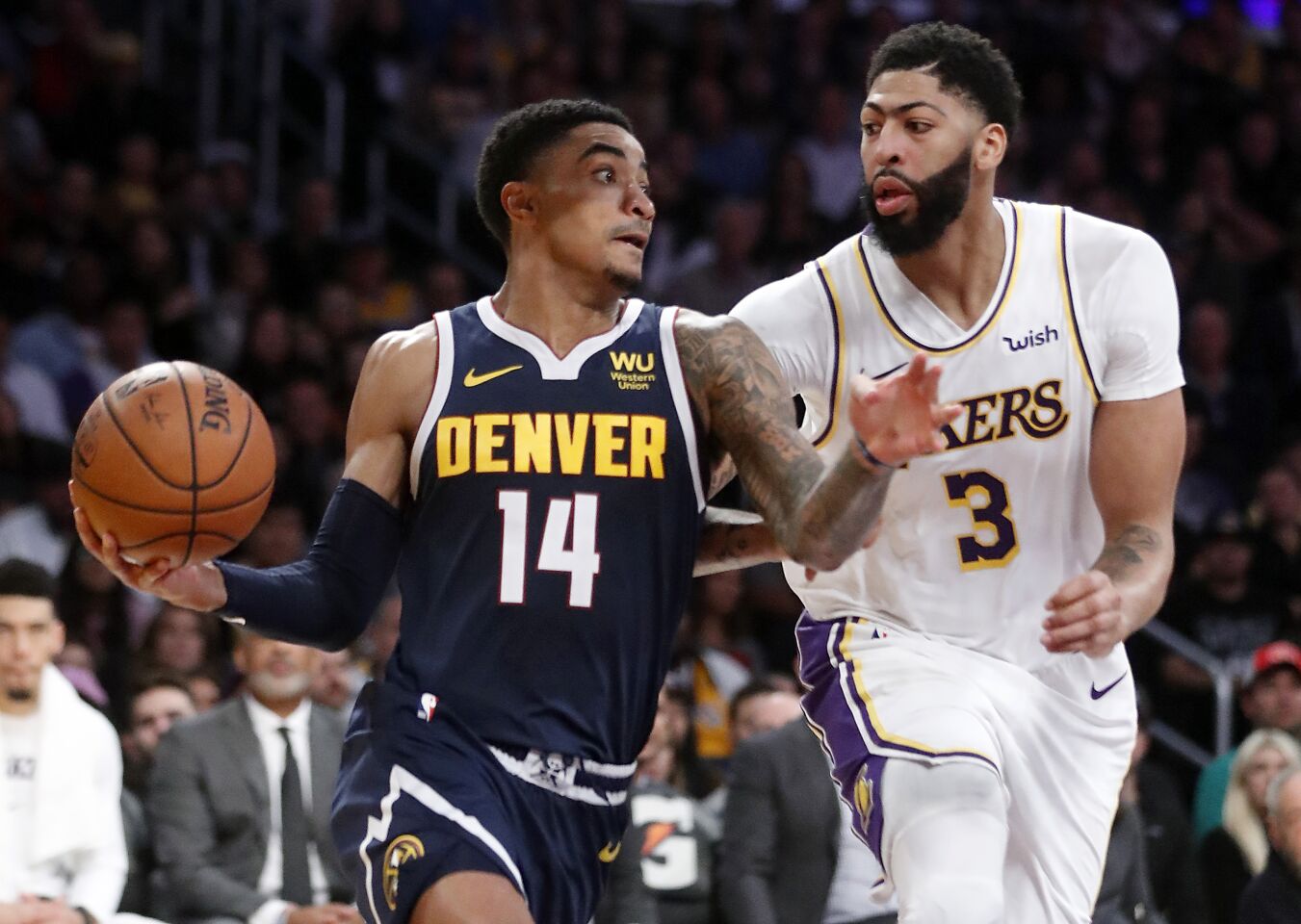Nuggets guard Gary Harris drives to the basket in front of Lakers forward Anthony Davis.