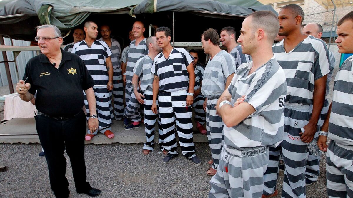Inmates gather around Sheriff Joe Arpaio as he walks through a Maricopa County jail called "Tent City" in Phoenix.