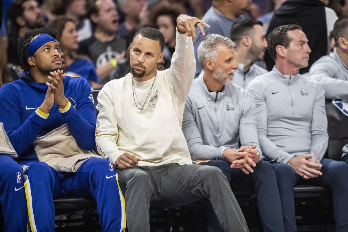 Golden State Warriors guard Stephen Curry reacts from the bench during the third quarter of a NBA basketball game against the Los Angeles Lakers in San Francisco, Calif. Thursday, April 7, 2022.(Stephen Lam/San Francisco Chronicle via AP)