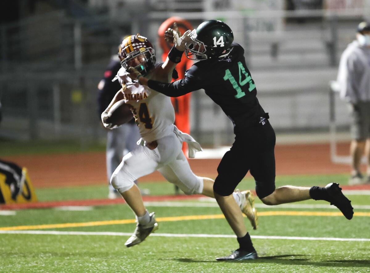 Estancia's Lucas Pacheco (34) runs for a score against Costa Mesa on Friday night.