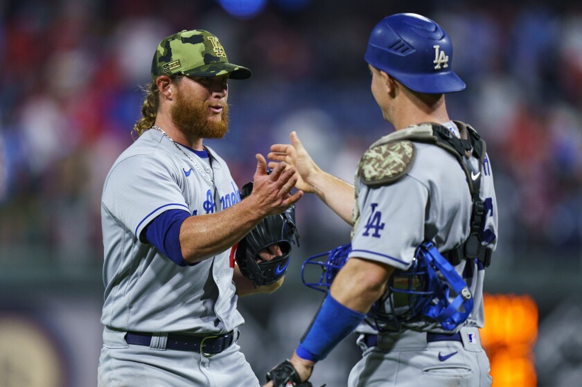 Dodgers closer Craig Kimbrel, left, greets catcher Will Smith after L.A.'s victory May 21, 2022.