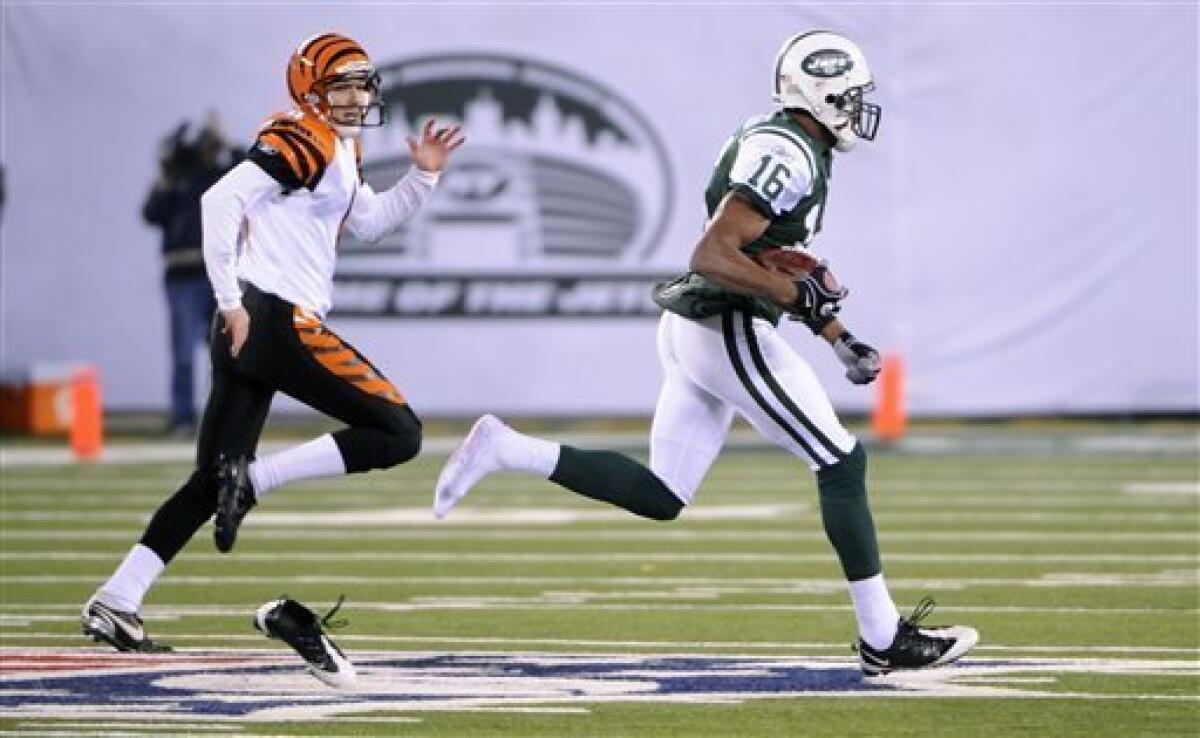 Cincinnati Bengals quarterback Carson Palmer (9) is sacked by New York Jets  linebacker Calvin Pace (97) and linebacker Jason Taylor (99) during the  fourth quarter of an NFL football game between the