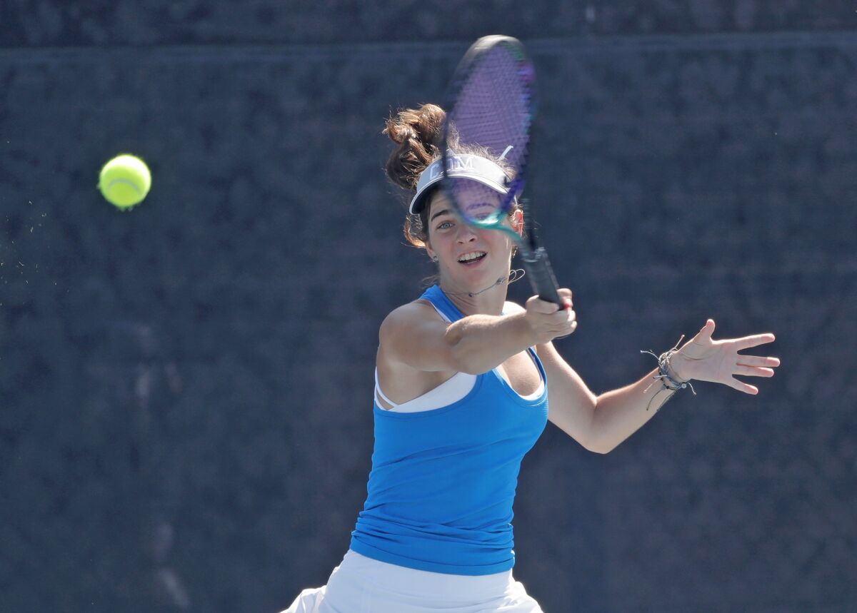 Sophia Andrei-Birca of Corona del Mar hits a hard forehand during Tuesday's match against Peninsula.