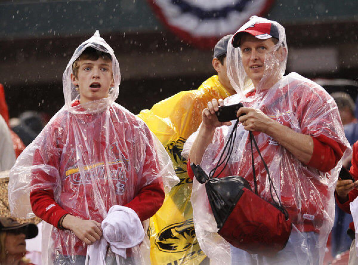 Cardinals fans wait out a 3 1/2-hour rain delay at Busch Stadium on Wednesday night in St. Louis.