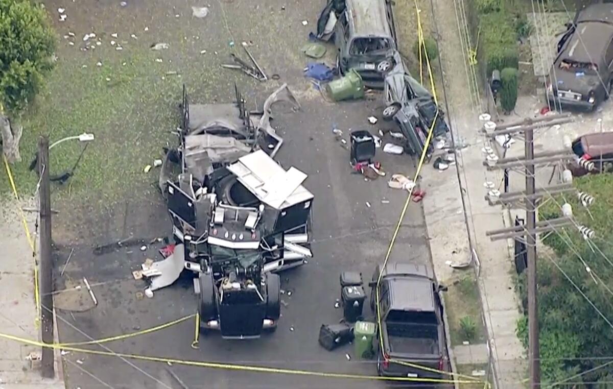 An aerial image shows the remains of an armored truck after an explosion