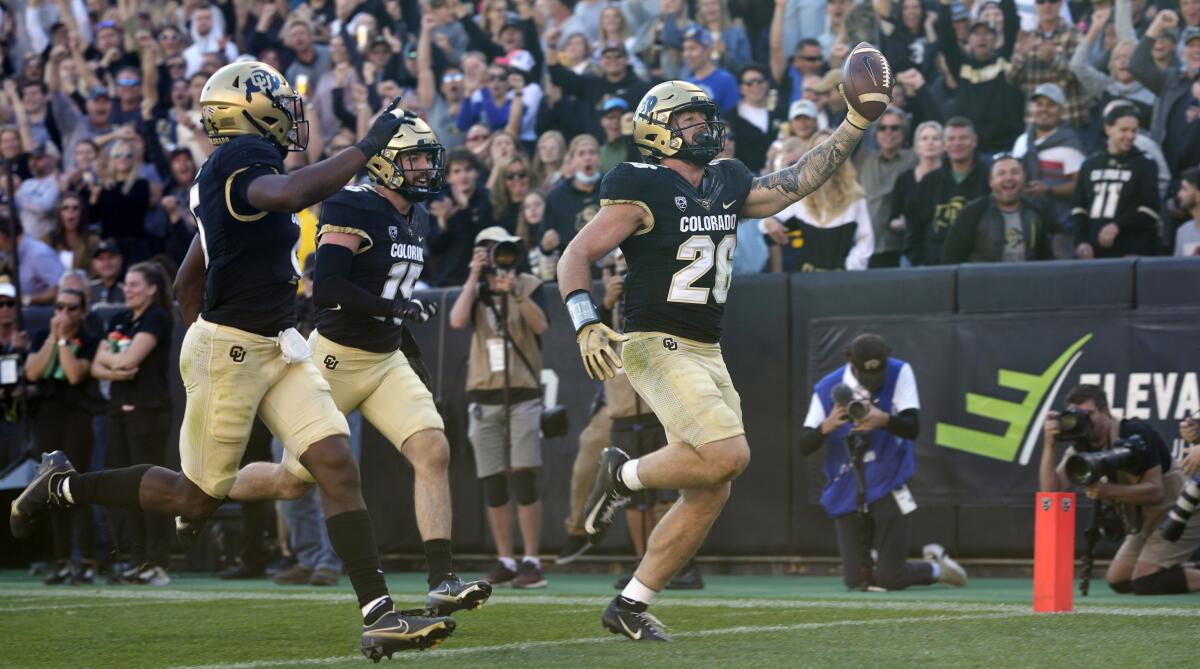 Colorado linebacker Carson Wells celebrates as he scores a touchdown Oct. 16, 2021, in Boulder, Colo.