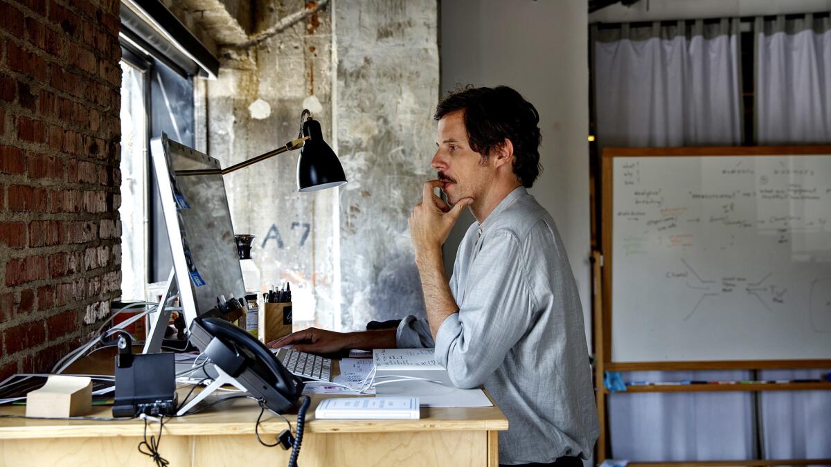 Wolfgang Hammer, president of Super Deluxe, works at his standing desk in his downtown office. "We're telling the audience: You can choose your own adventure," he said. (Jay L. Clendenin / Los Angeles Times)