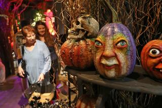 Artist Vergie Lightfoot's expressive pumpkings on display at Roger's Gardens annual Halloween boutique, ushering in spooky season decor to Newport Beach. This year's installment is called "The Gathering" centers around a witchy theme.