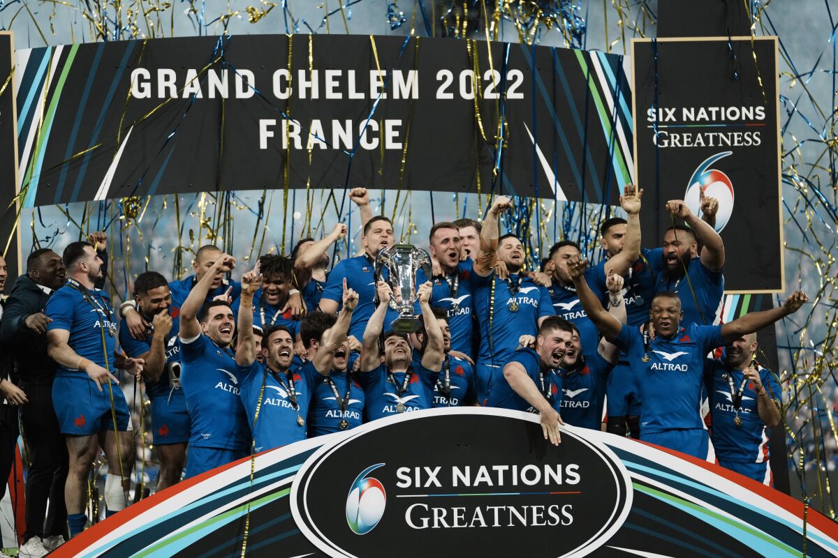 FILE - France's Antoine Dupont raises the trophy as he celebrates with teammates after the Six Nations rugby union international match between France and England at the Stade de France in Saint-Denis, near Paris, Saturday, March 19, 2022. The 2023 Six Nations starts on Feb. 4. (AP Photo/Thibault Camus, File)