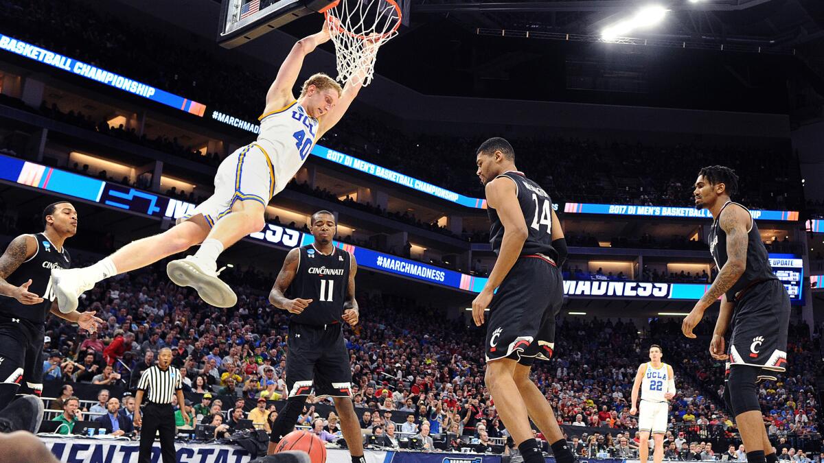 UCLA center Thomas Welsh throws down a dunk against Cincinnati in the second half of an NCAA tournament game March 19.