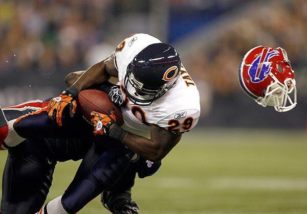 The helmet of a Buffalo Bills defender flies through the air after he makes the hit on Chicago Bears running back Chester Taylor in the second quarter of an NFL game on Sunday at the Rogers Centre in Toronto, Canada.