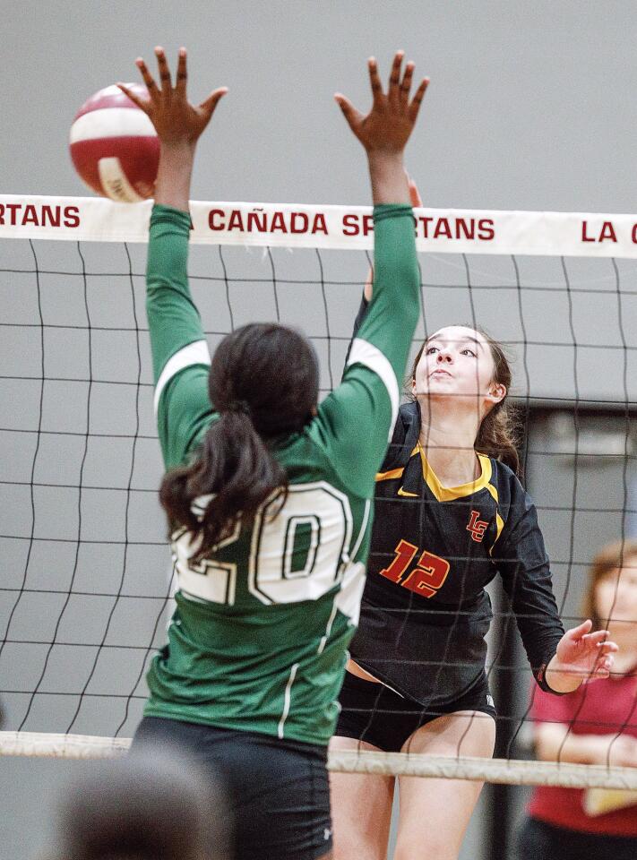 La Canada's Kimberly Callister hits the ball passed Blair's Kaleah Howell in a Rio Hondo League girls' volleyball match at La Canada High School on Wednesday, October 10, 2018. La Canada swept Blair 3-0.
