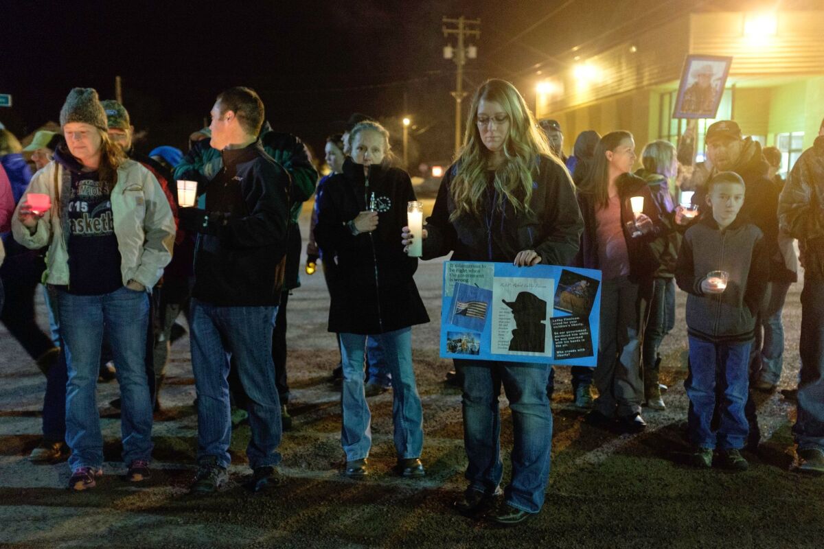 More than 20 people marched through Burns, Ore., to celebrate the life of Robert "LaVoy" Finicum, who was fatally shot during an encounter with the FBI and other agencies.