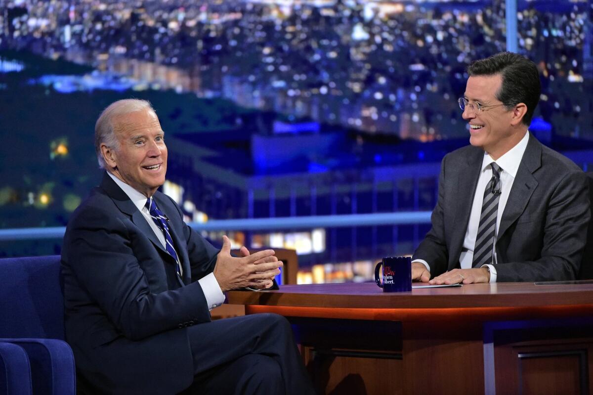 Stephen Colbert, right, smiles as he talks with Vice President Joe Biden during a taping of "The Late Show with Stephen Colbert," on Sept. 10, 2015.